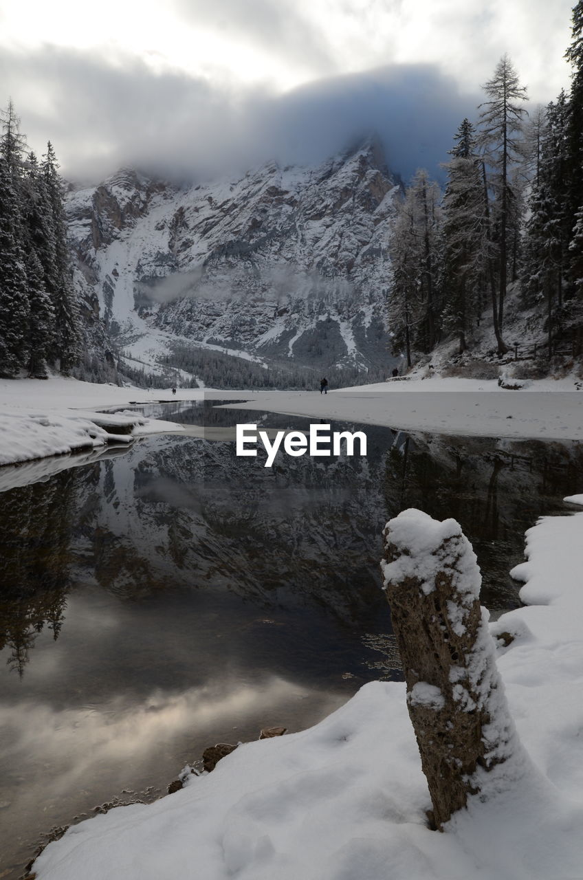 Scenic view of river against cloudy sky during winter