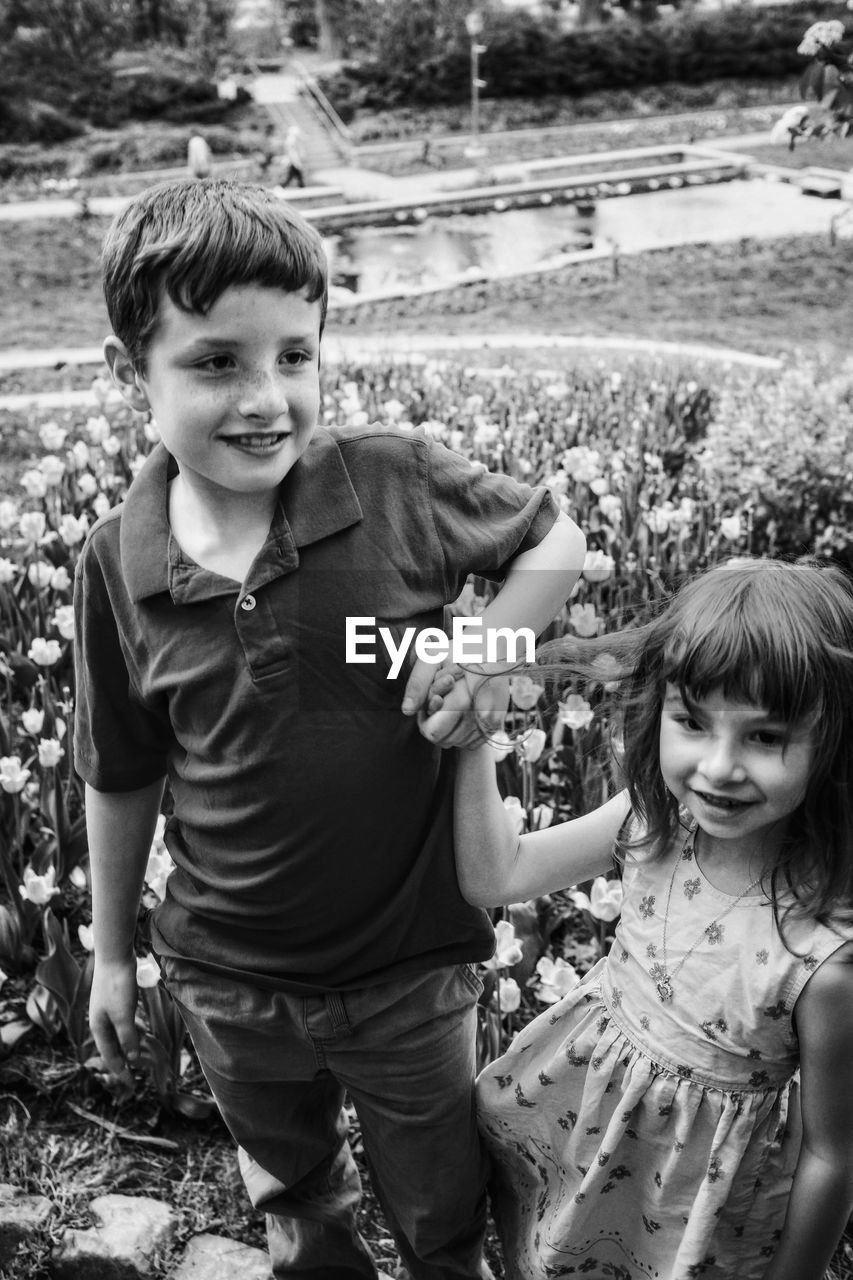 Siblings standing at park