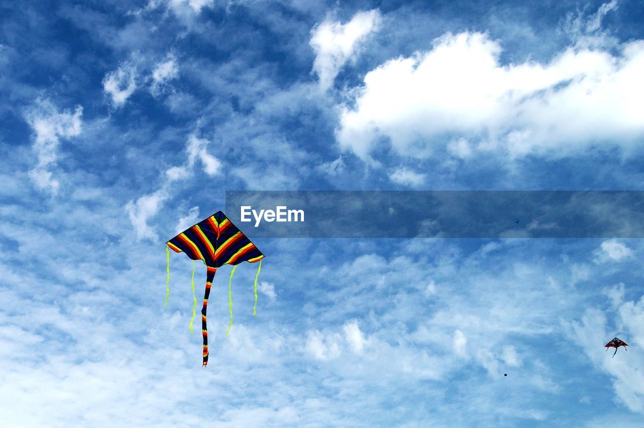 Low angle view of kite flying against sky