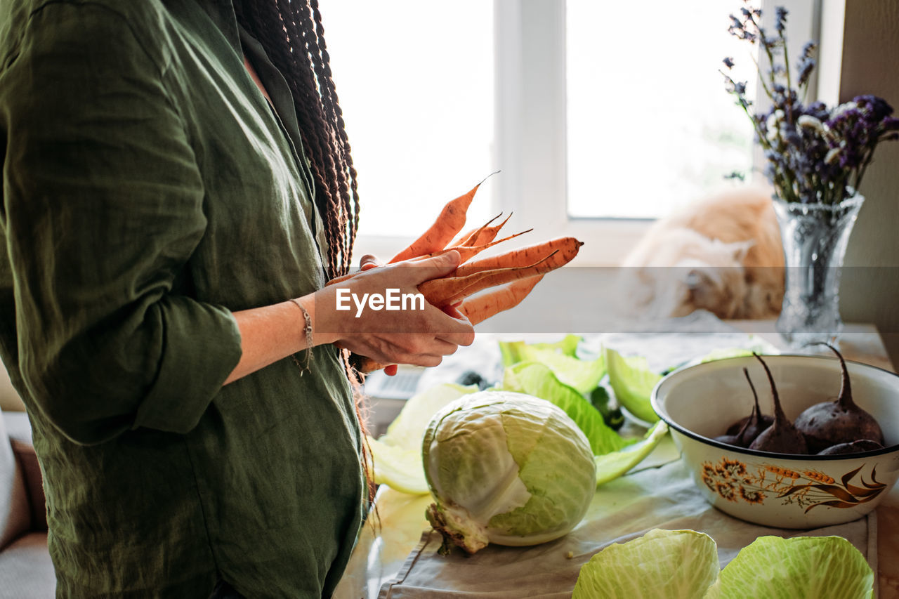 Faceless portrait of vegan woman holding vegetables. veganism, vegetarianism, plant-based diet
