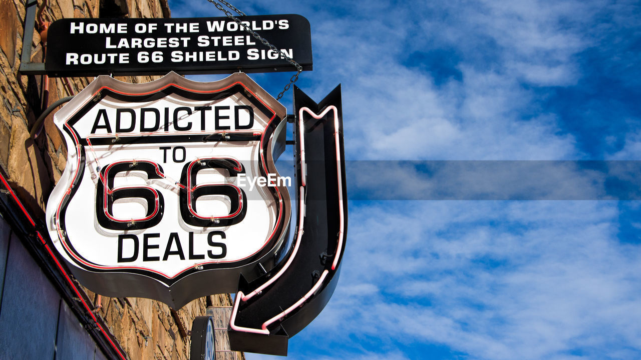 LOW ANGLE VIEW OF SIGN AGAINST SKY