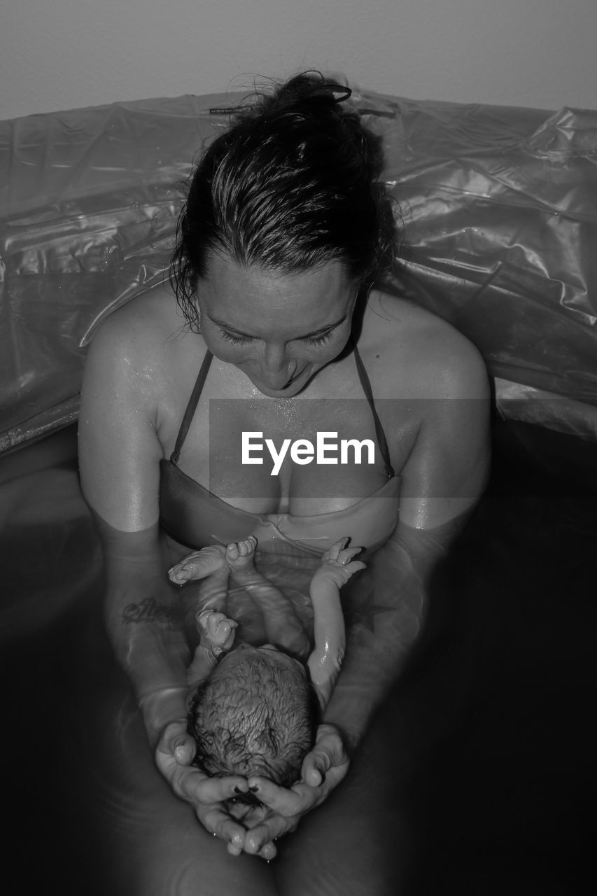 High angle view of mother and son taking bath in bathroom