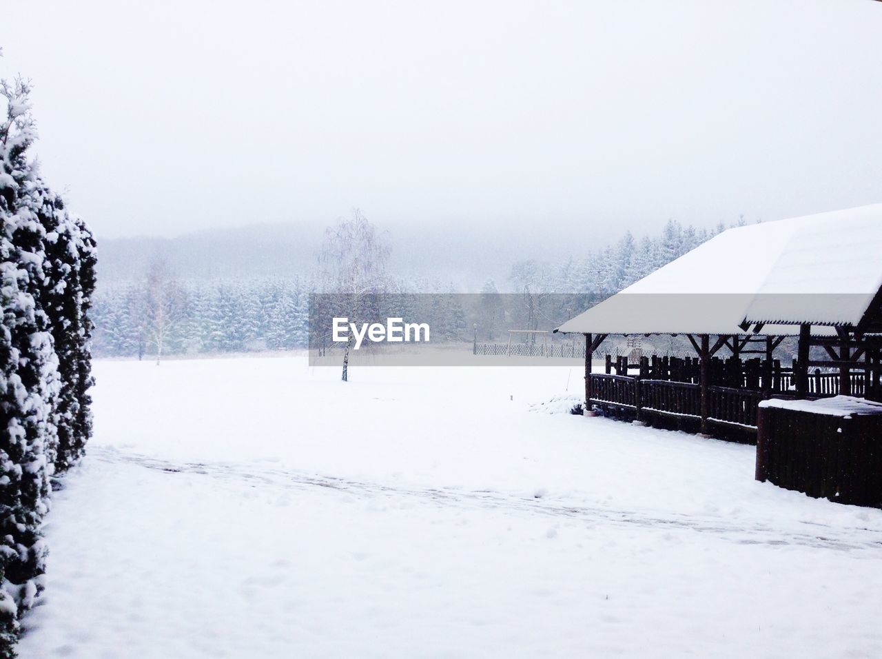 House on snowcapped field during winter