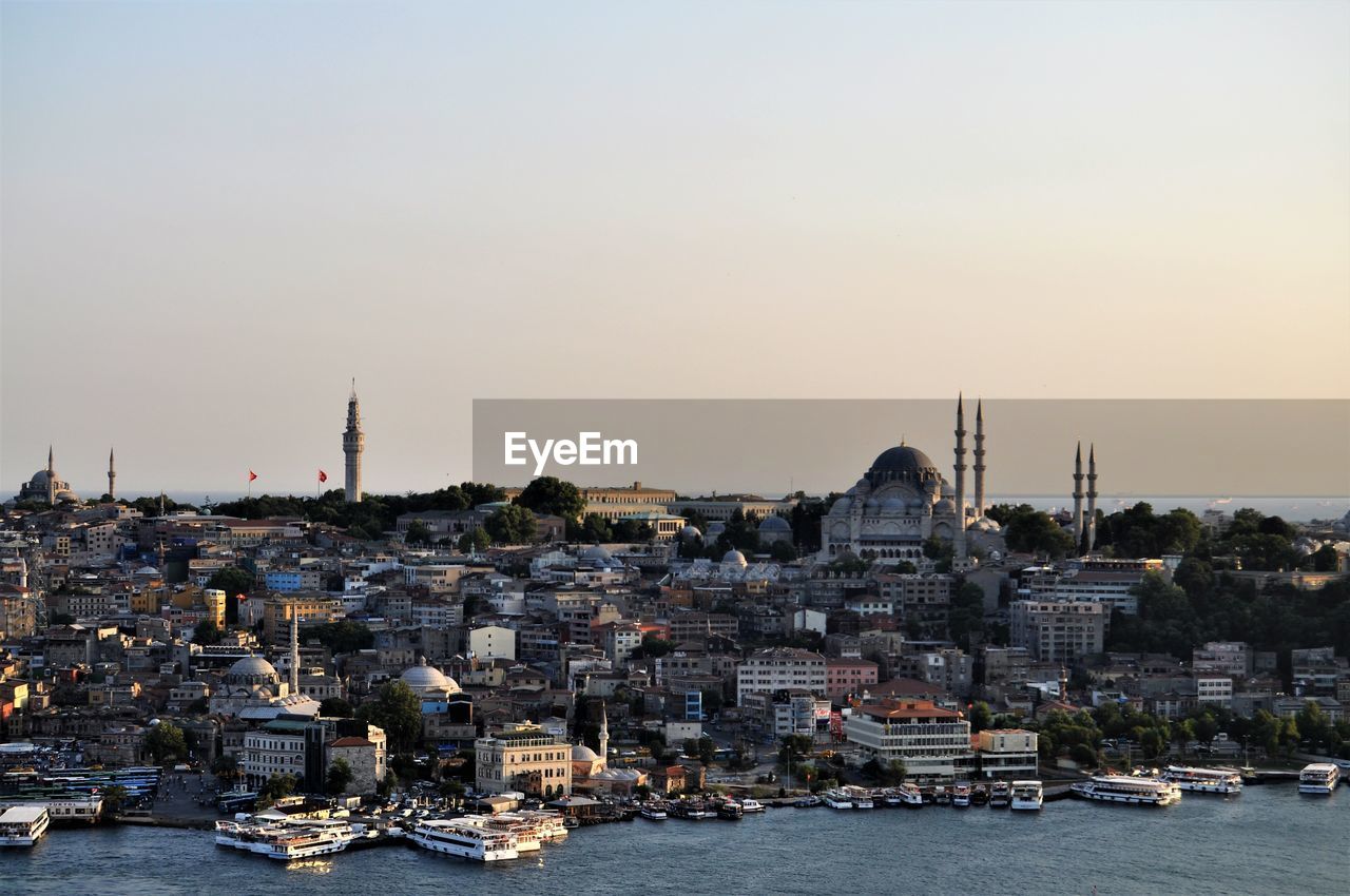 View of buildings in city against clear sky