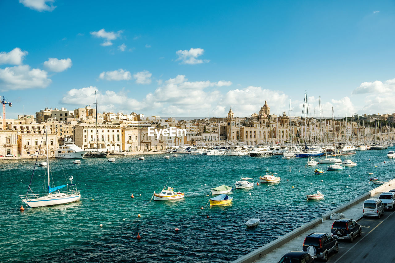 Sailing boats in harbor in front of historical scenery in malta