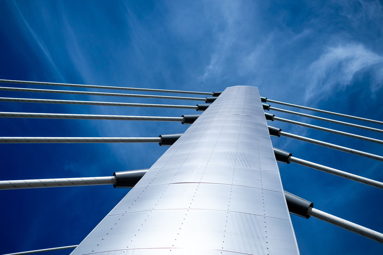 Low angle view of bridge beams against sky