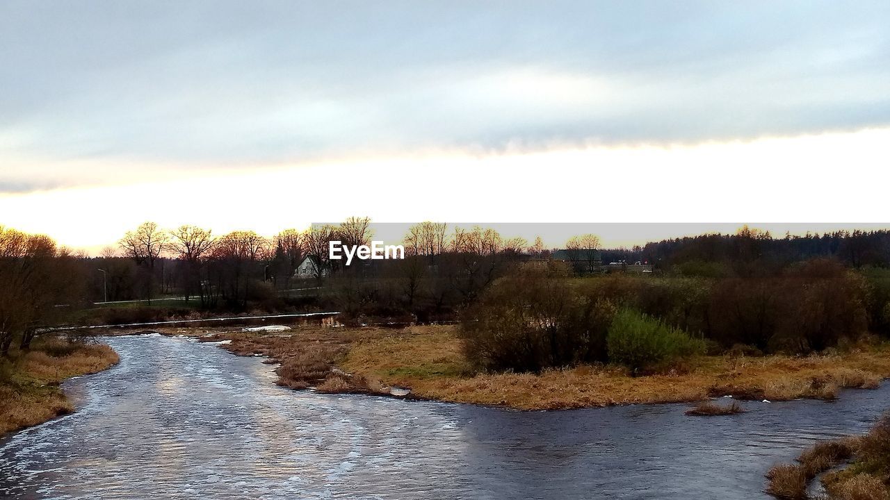 SCENIC VIEW OF RIVER AGAINST SKY AT FOREST