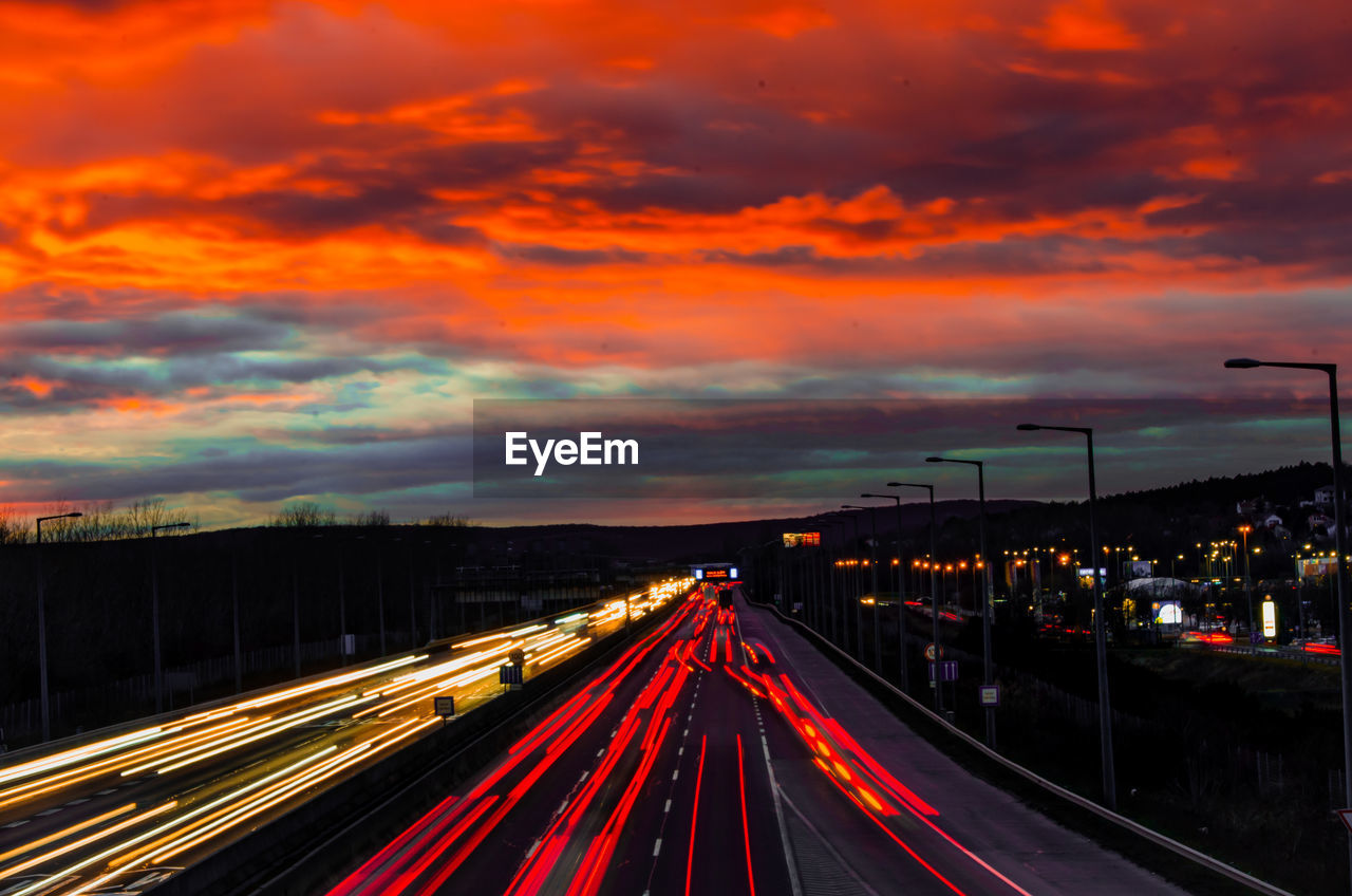 Light trails on highway at sunset