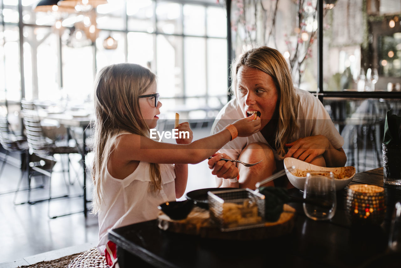 Mother and daughter in restaurant