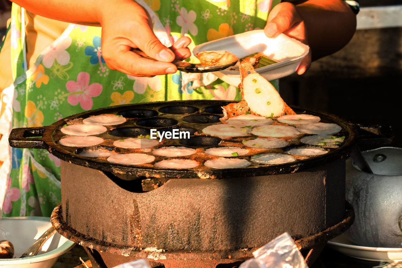 Midsection of man preparing food