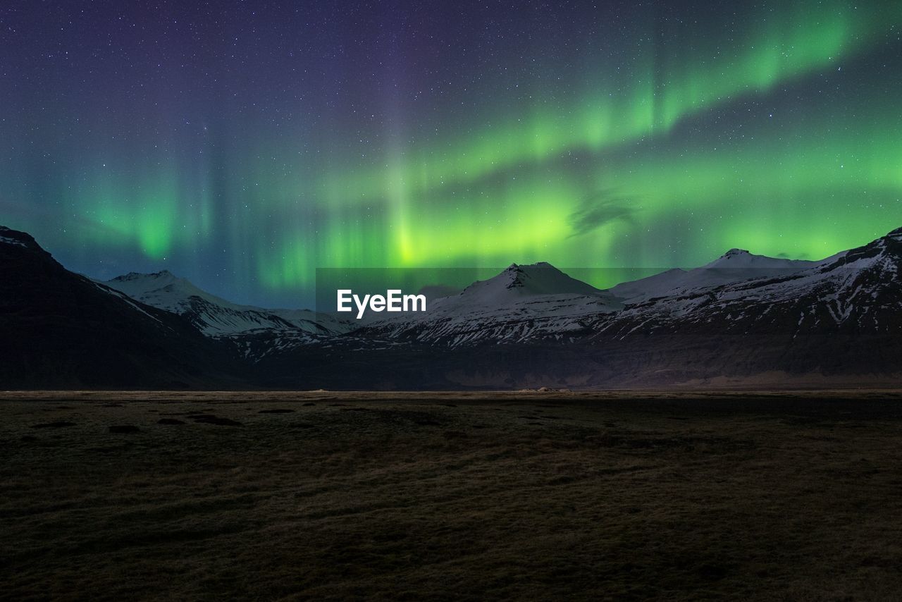 Scenic view of mountains against sky at night