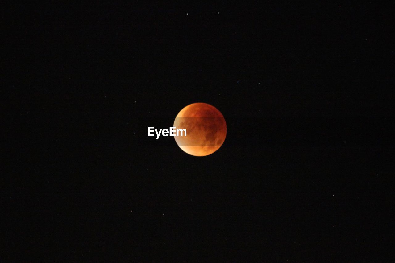 LOW ANGLE VIEW OF MOON IN SKY AT NIGHT