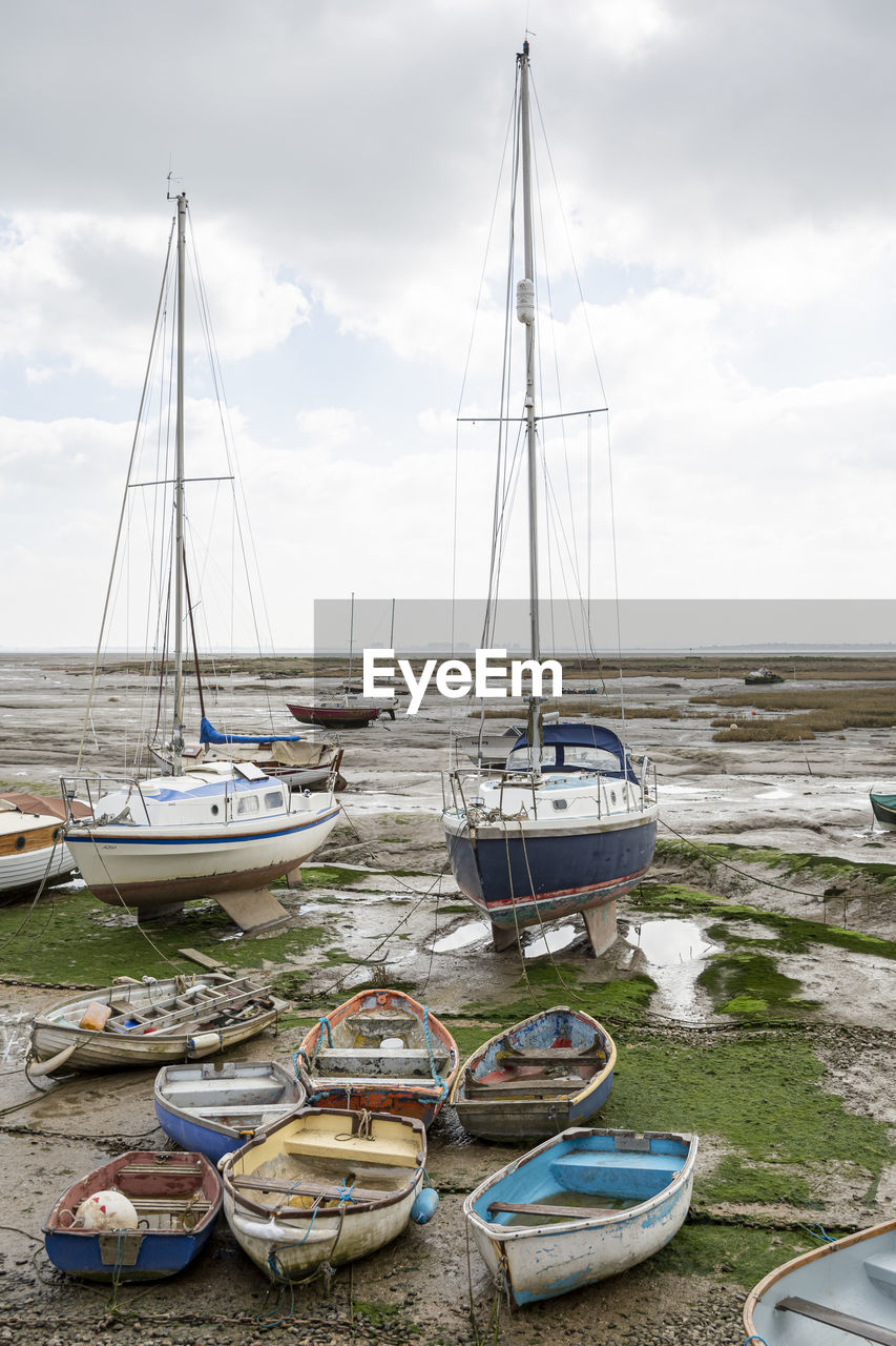 Fisherman boats stuck on the beach in low tide period in leigh-on-sea, uk.