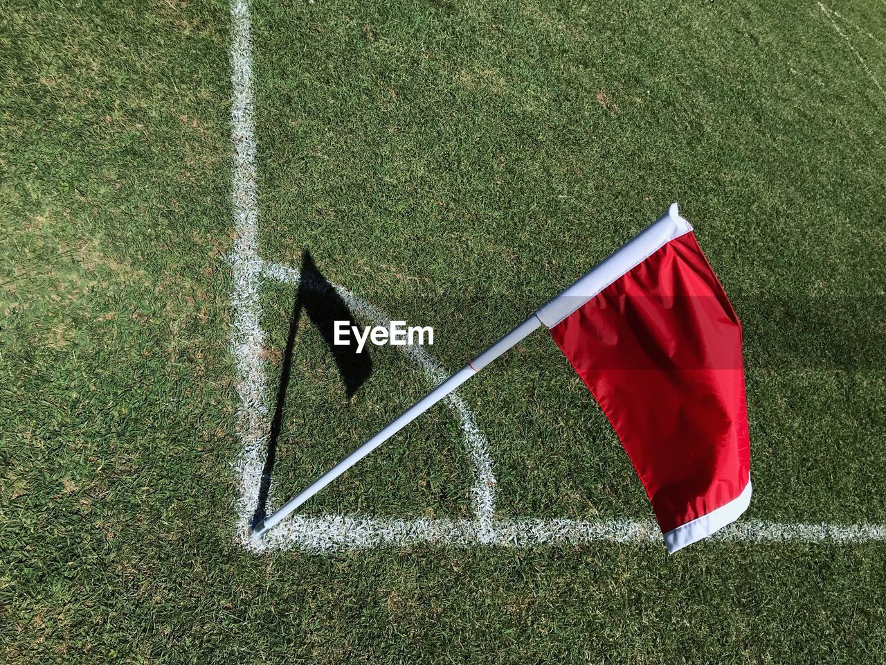 High angle view of red flag on soccer field during sunny day
