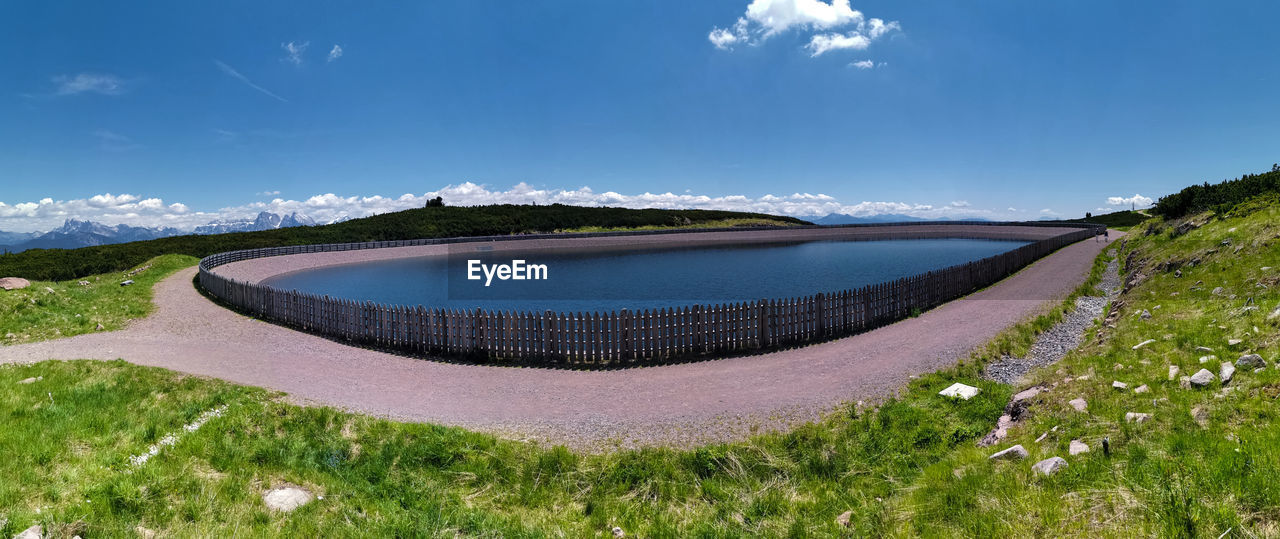 Panoramic shot reservoir lake, alto badia against sky