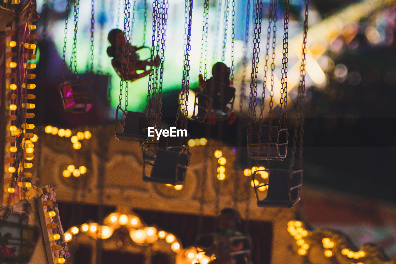 CLOSE-UP OF ILLUMINATED LIGHTING EQUIPMENT HANGING ON WALL