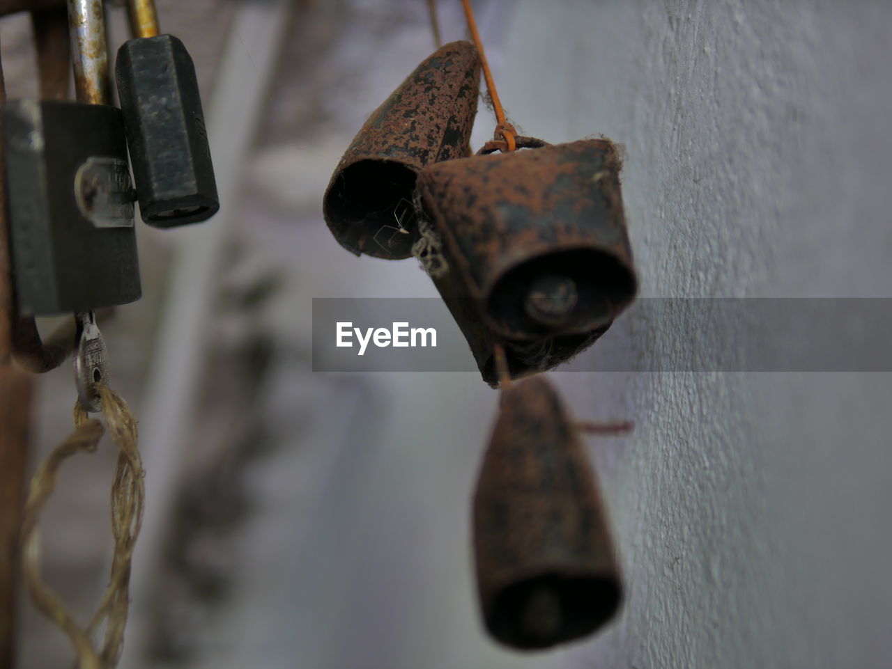 hanging, iron, metal, close-up, no people, focus on foreground, rusty, lock, old, wall - building feature, selective focus, lighting, day