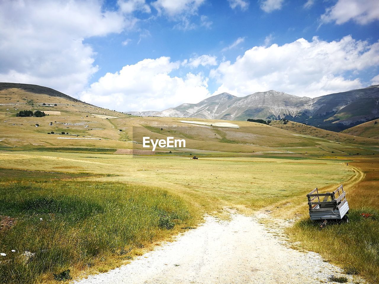 Scenic view of field and mountains against sky