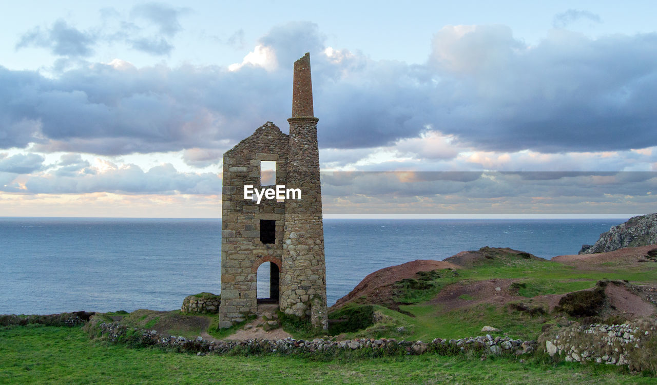 CASTLE ON SEA SHORE AGAINST SKY