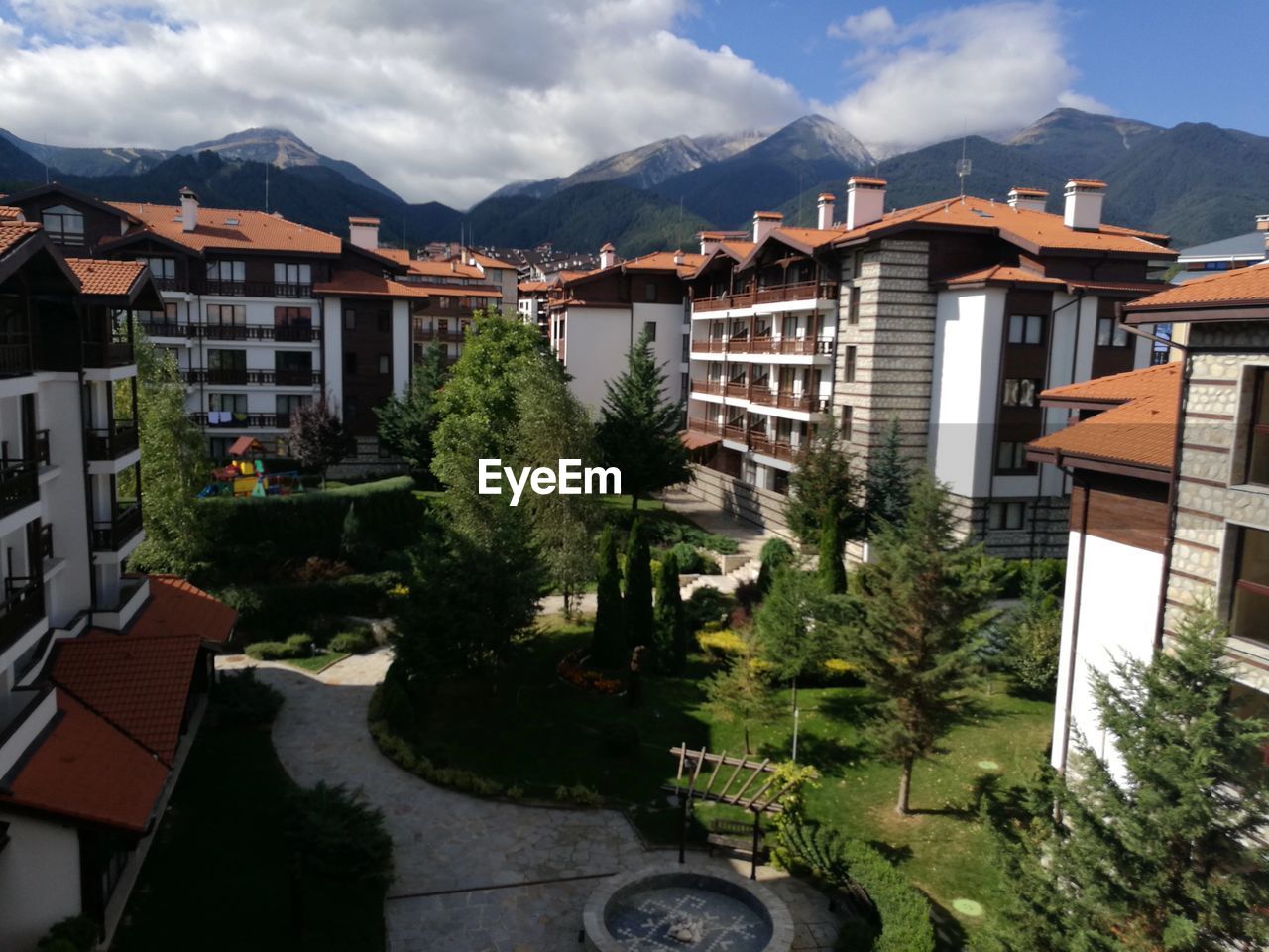 HOUSES IN TOWN BY MOUNTAIN AGAINST SKY