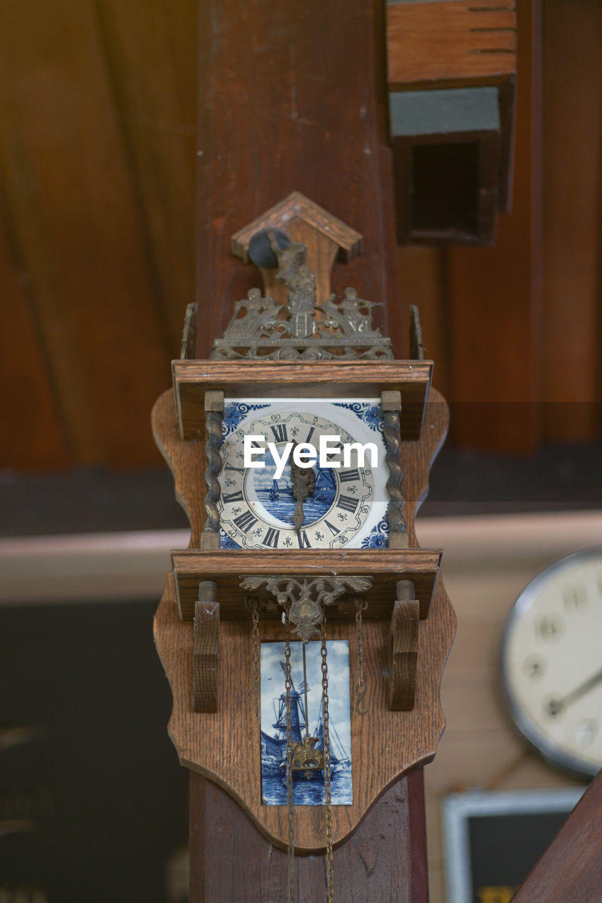 CLOSE-UP OF CLOCK ON METAL STRUCTURE