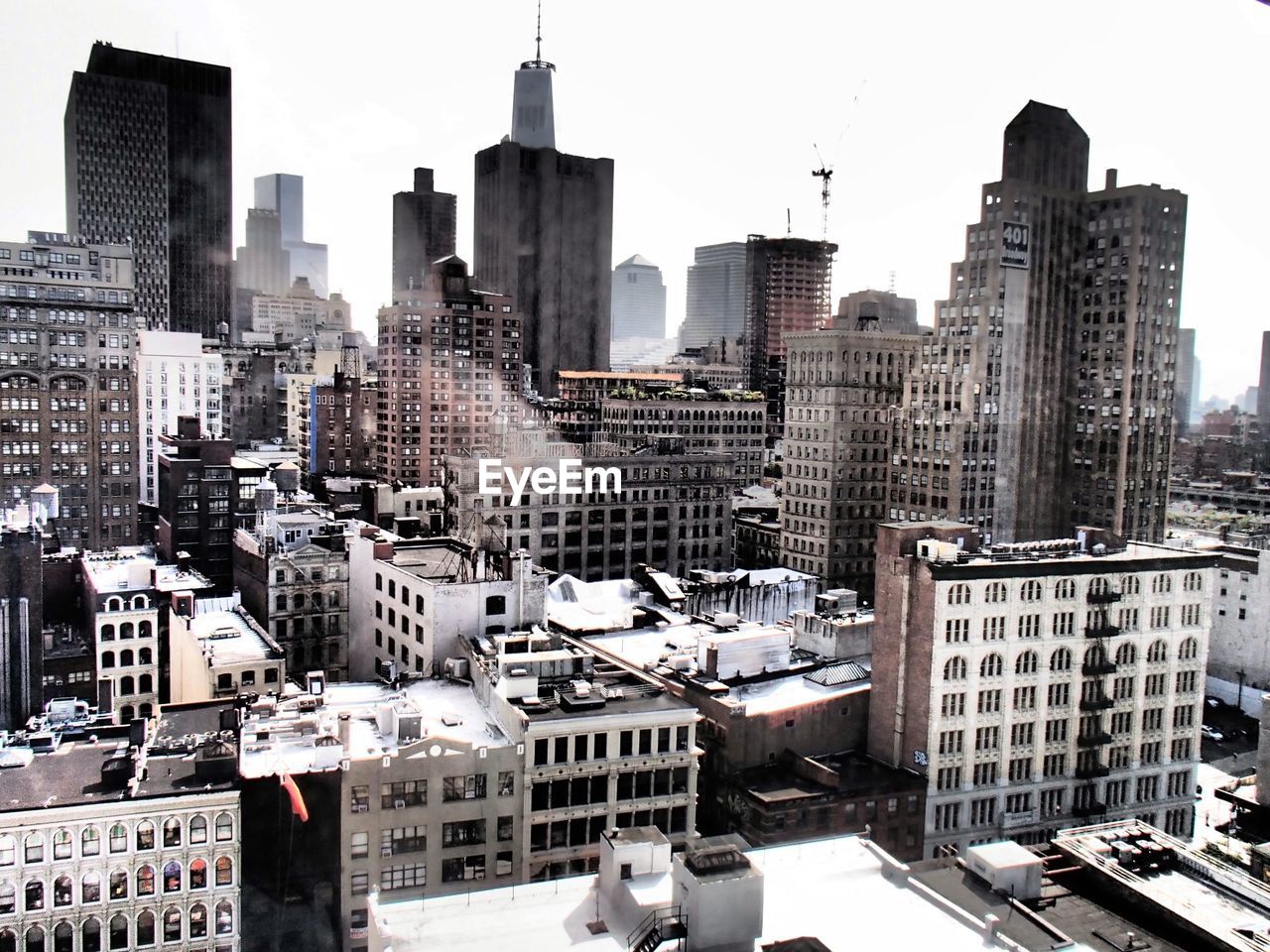 Crowded cityscape against sky