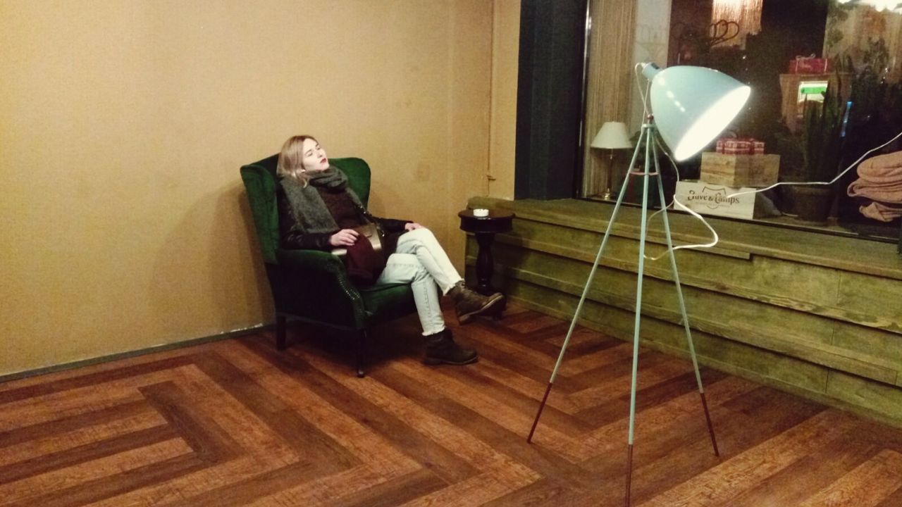 MAN SITTING ON FLOOR IN ROOM