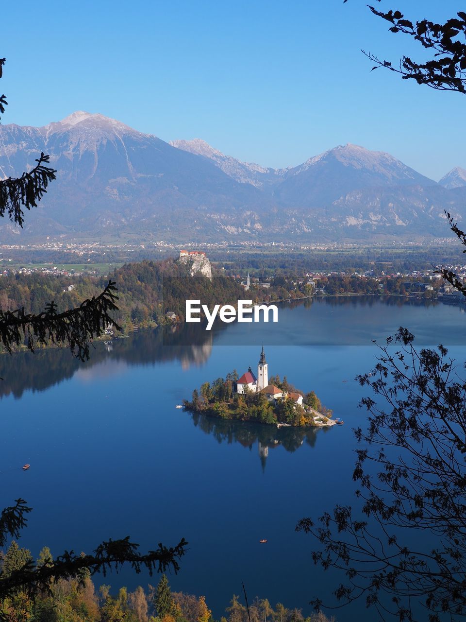 Scenic view of lake and mountains against blue sky