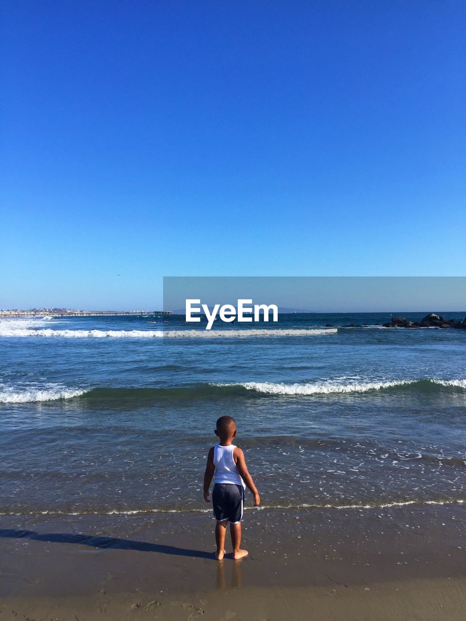 Boy standing on calm beach