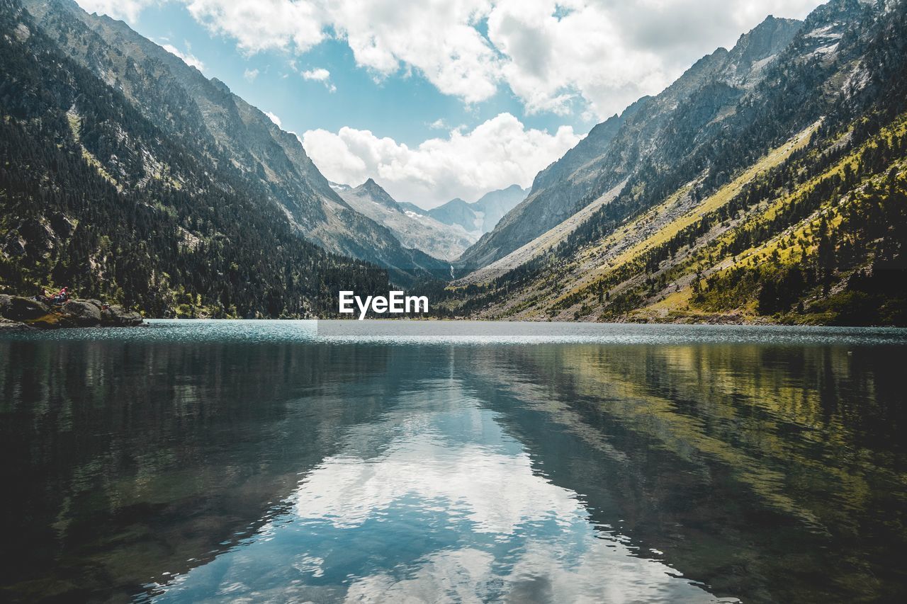 Scenic view of lake and mountains against sky