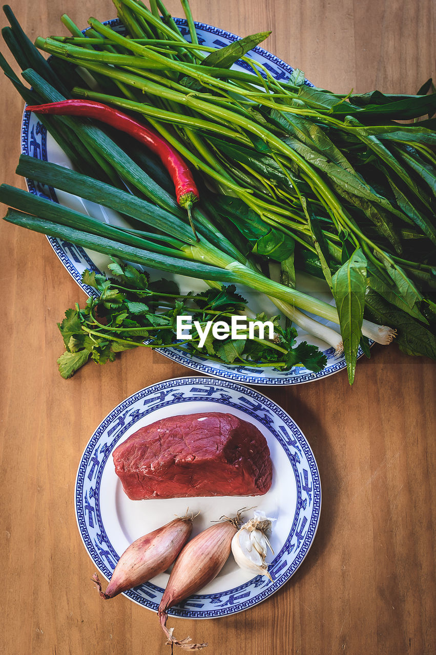 High angle view of beef with ingredients on table