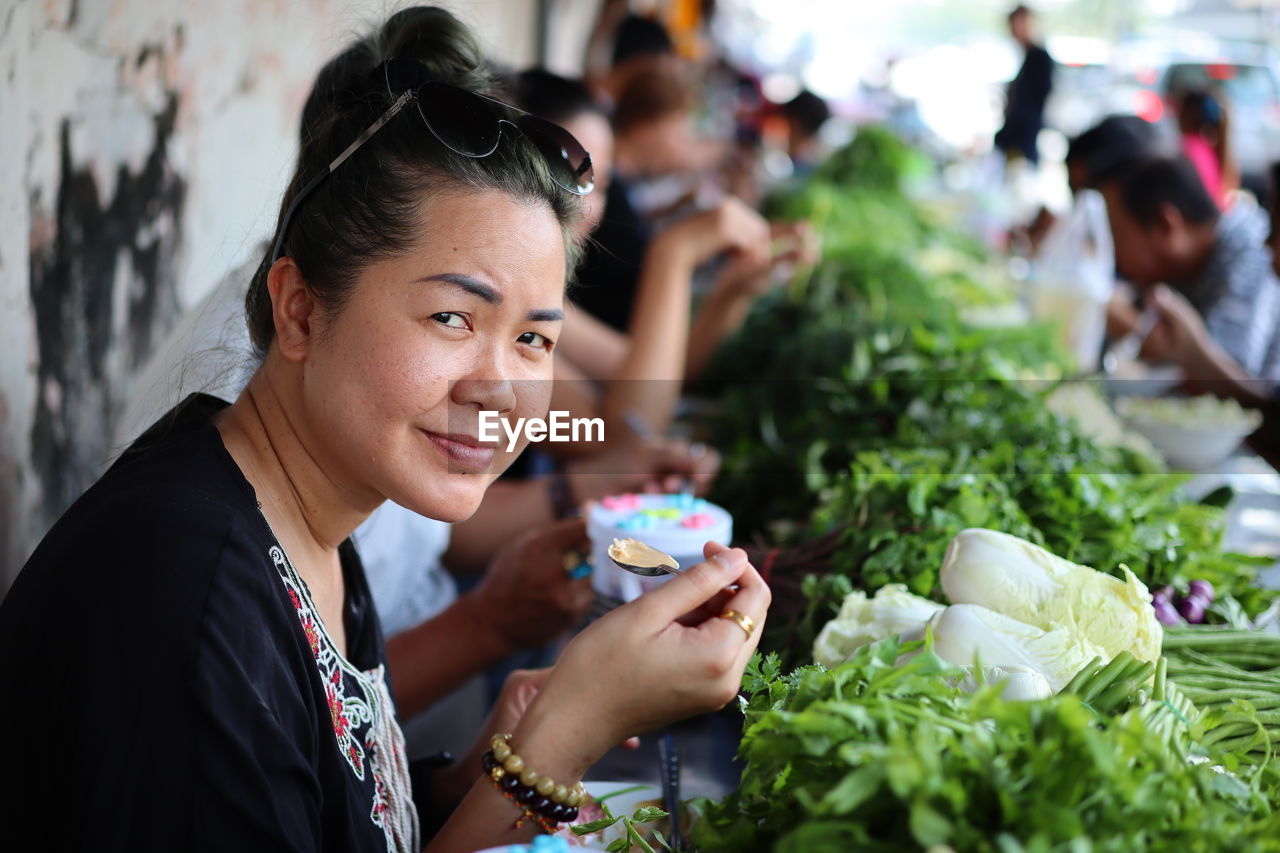 Portrait of woman eating street food