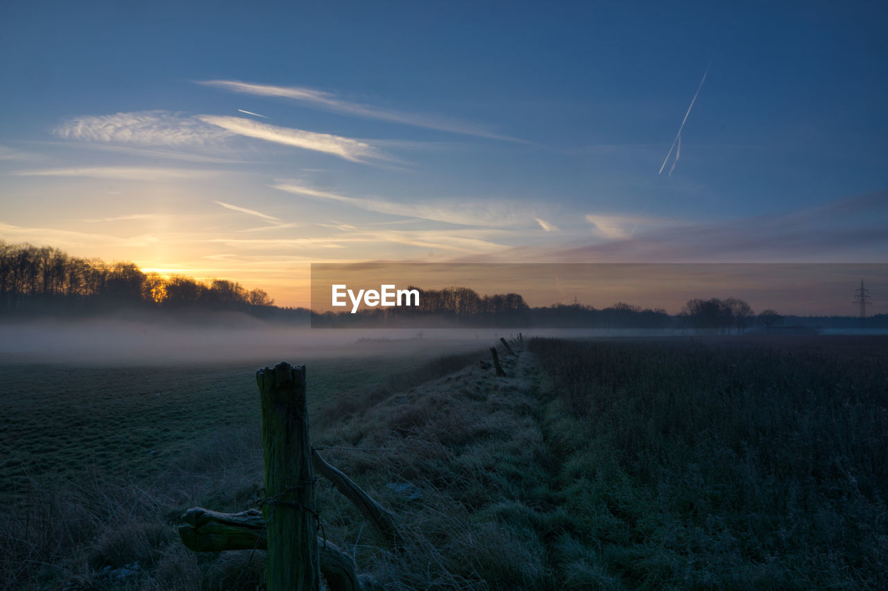 SCENIC VIEW OF LAND AGAINST SKY DURING SUNSET