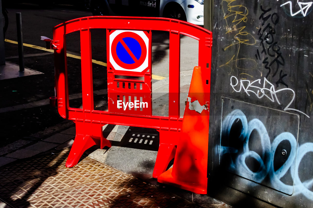 Barricade with forbidden sign on street during sunny day