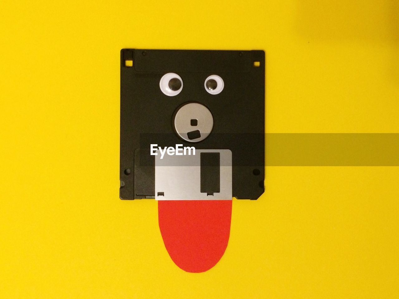 Anthropomorphic floppy disk against yellow background