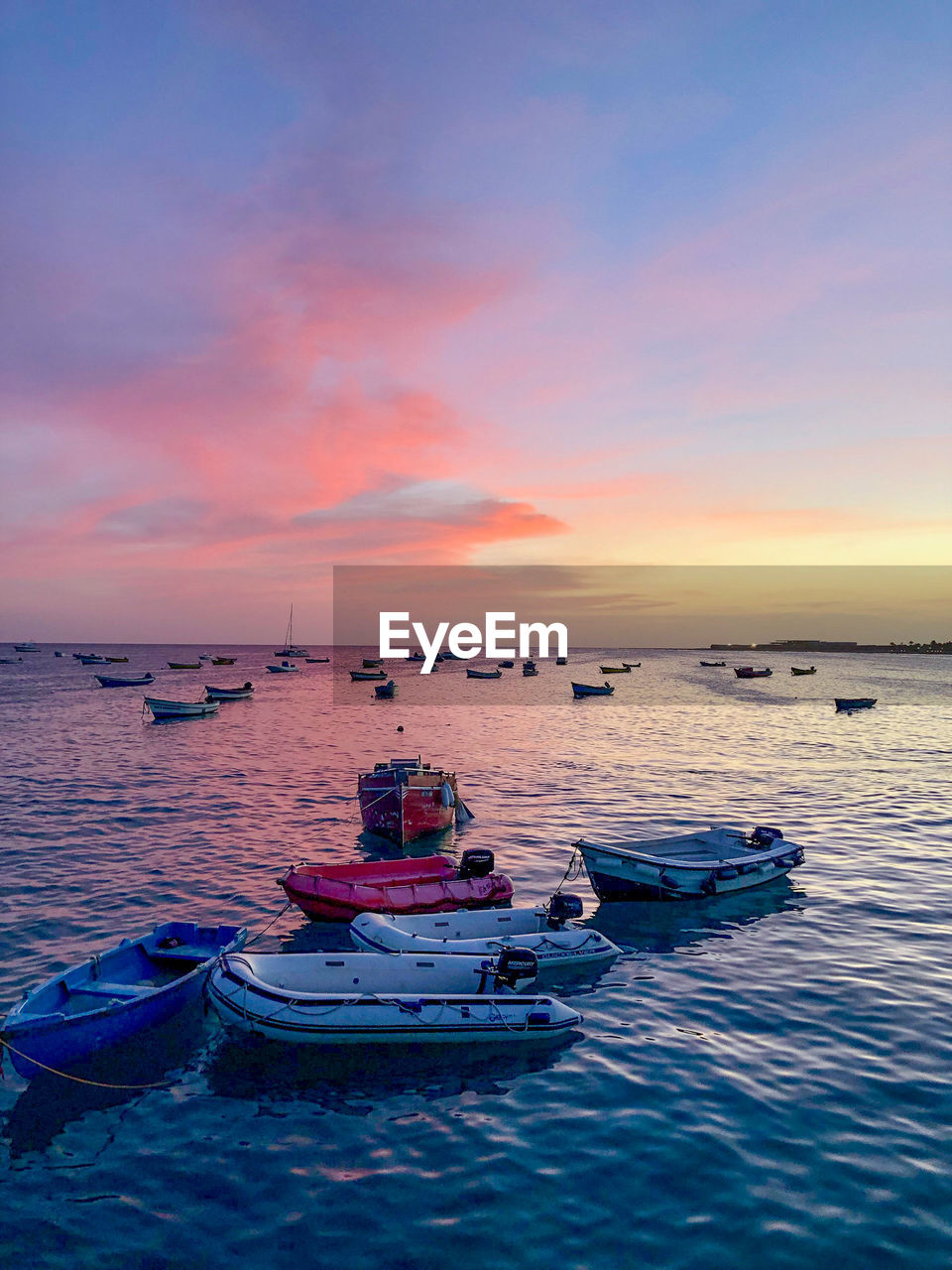 VIEW OF BOATS IN SEA AT SUNSET