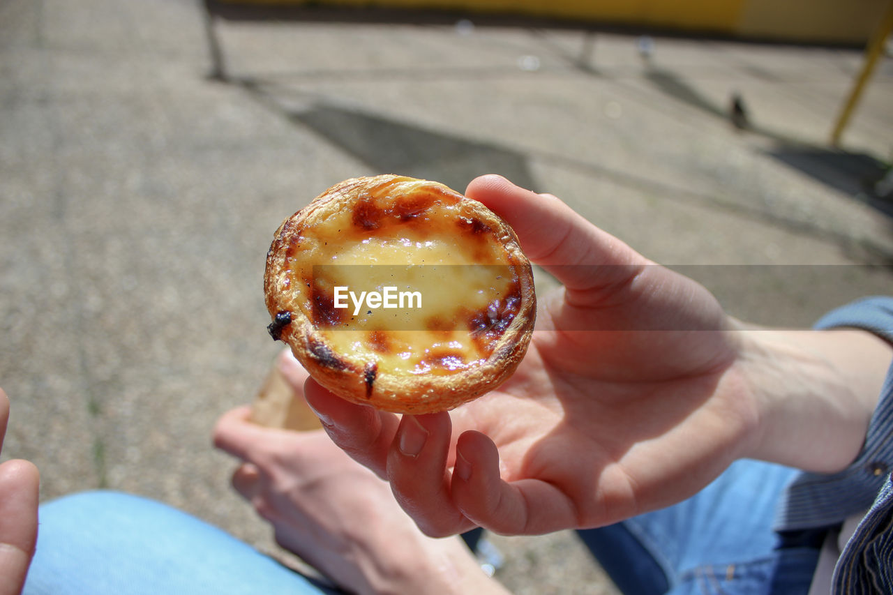 High angle view of person holding tart