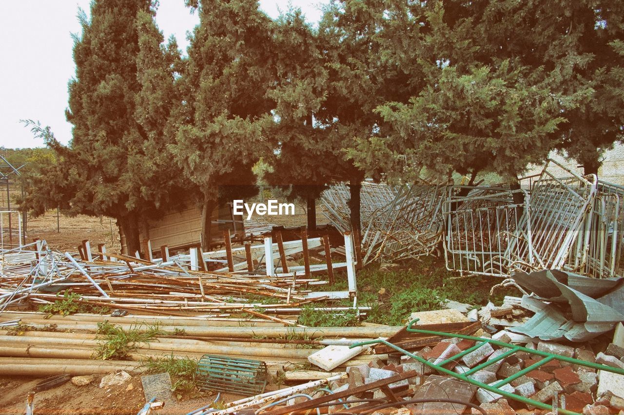 Abandoned broken structure against trees