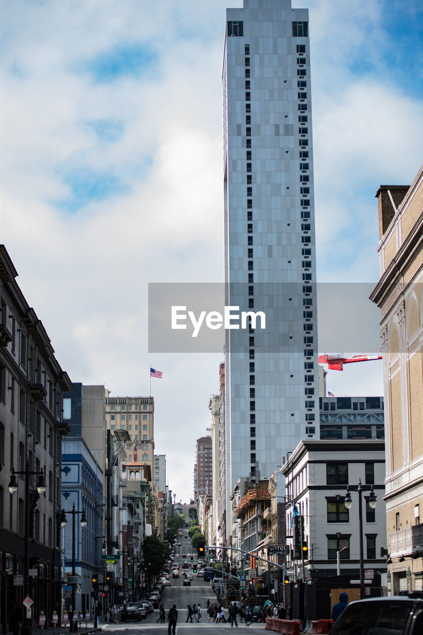 VIEW OF CITY STREET AND BUILDINGS AGAINST SKY