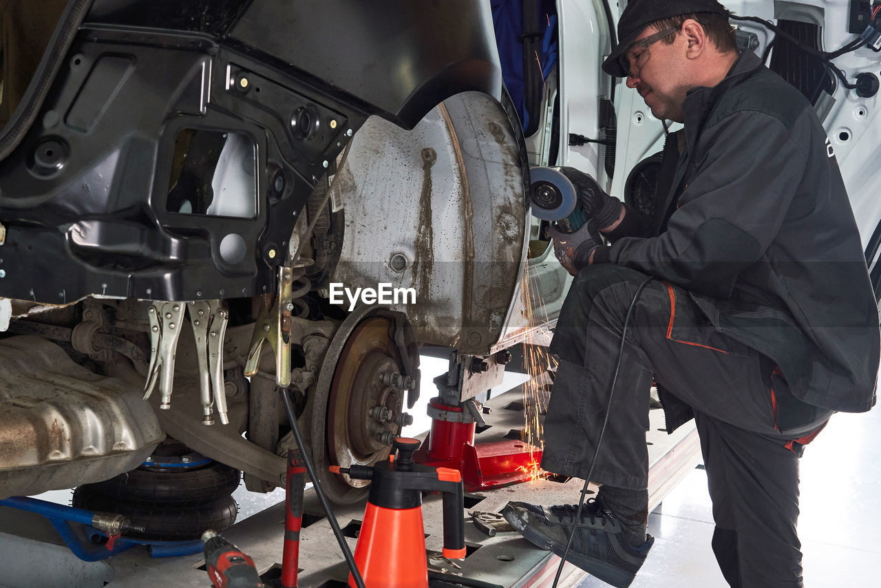 Mechanic repairing car