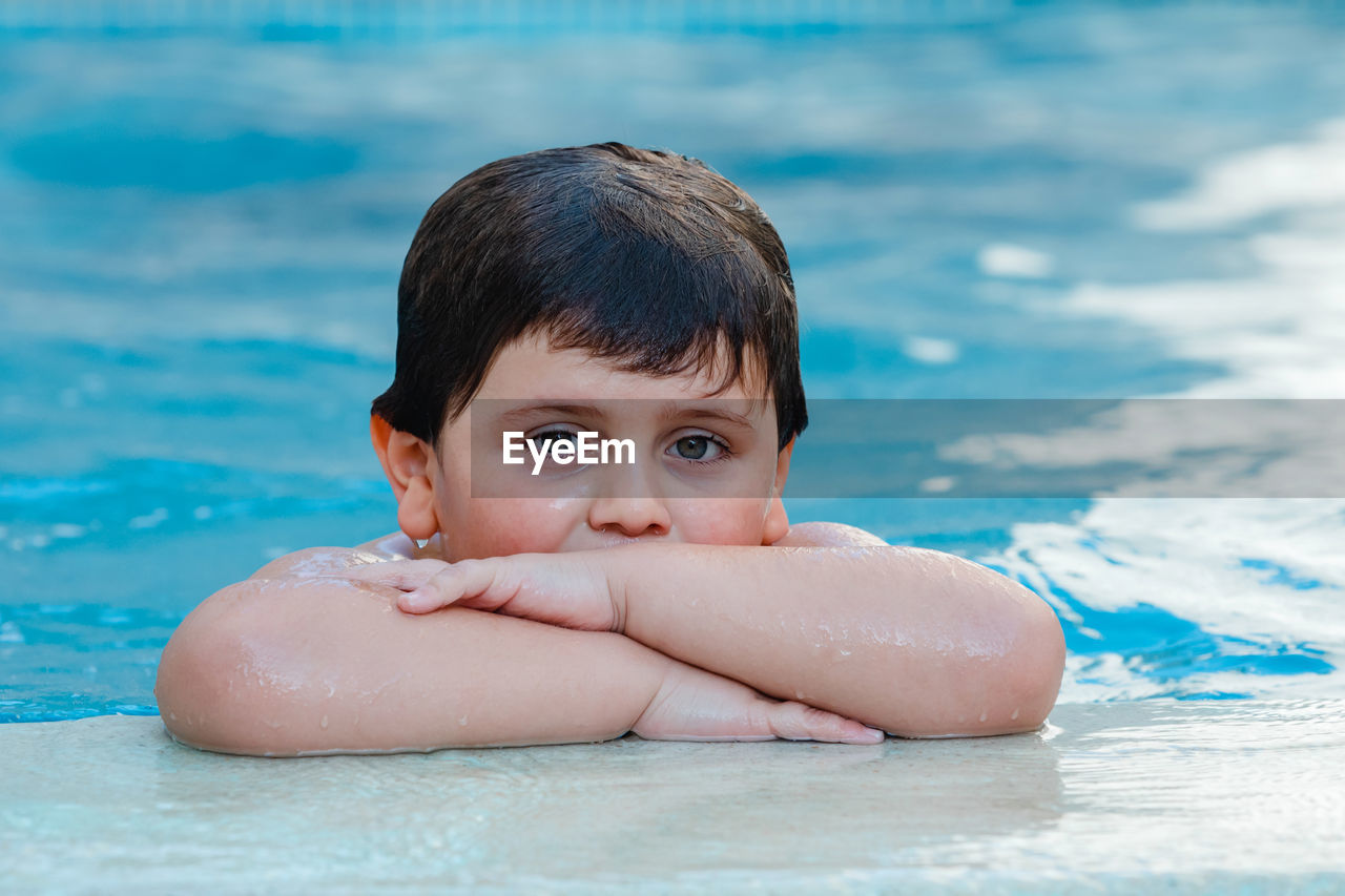 Portrait of shirtless boy in swimming pool