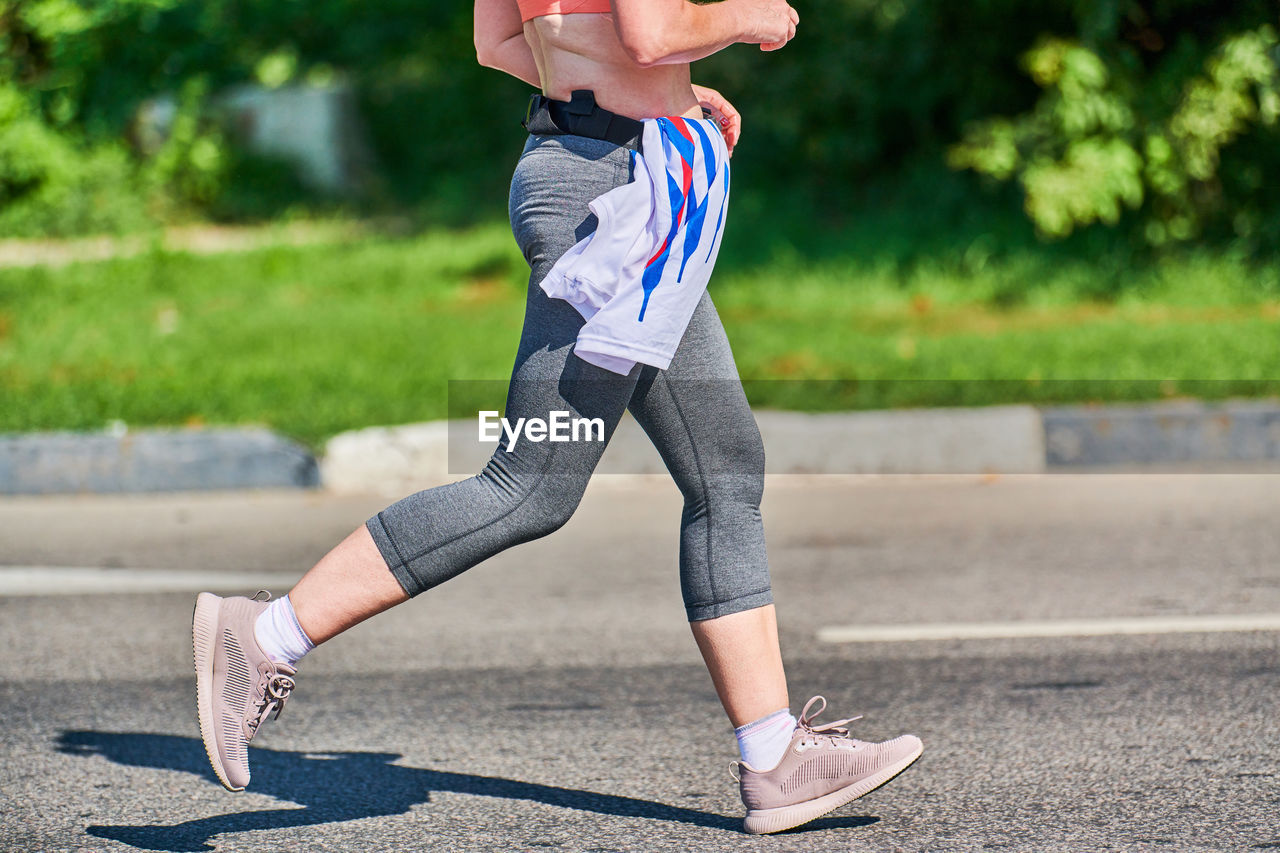 Low section of woman on footpath