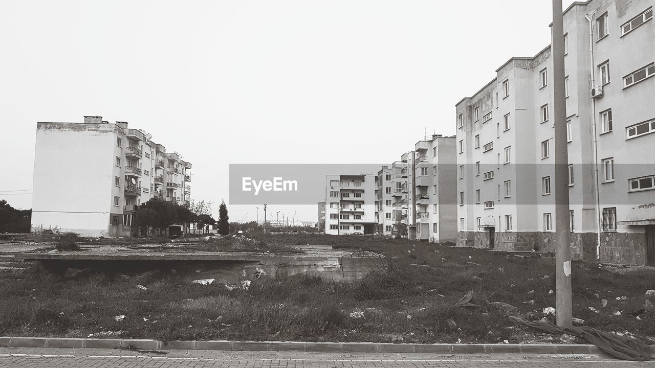 RIVER BY BUILDINGS AGAINST CLEAR SKY