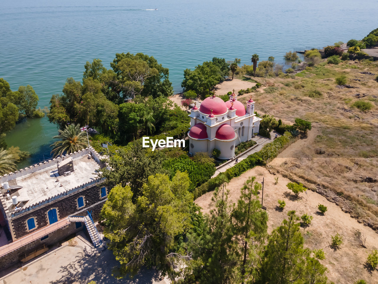 HIGH ANGLE VIEW OF PLANTS BY SWIMMING POOL AGAINST SEA