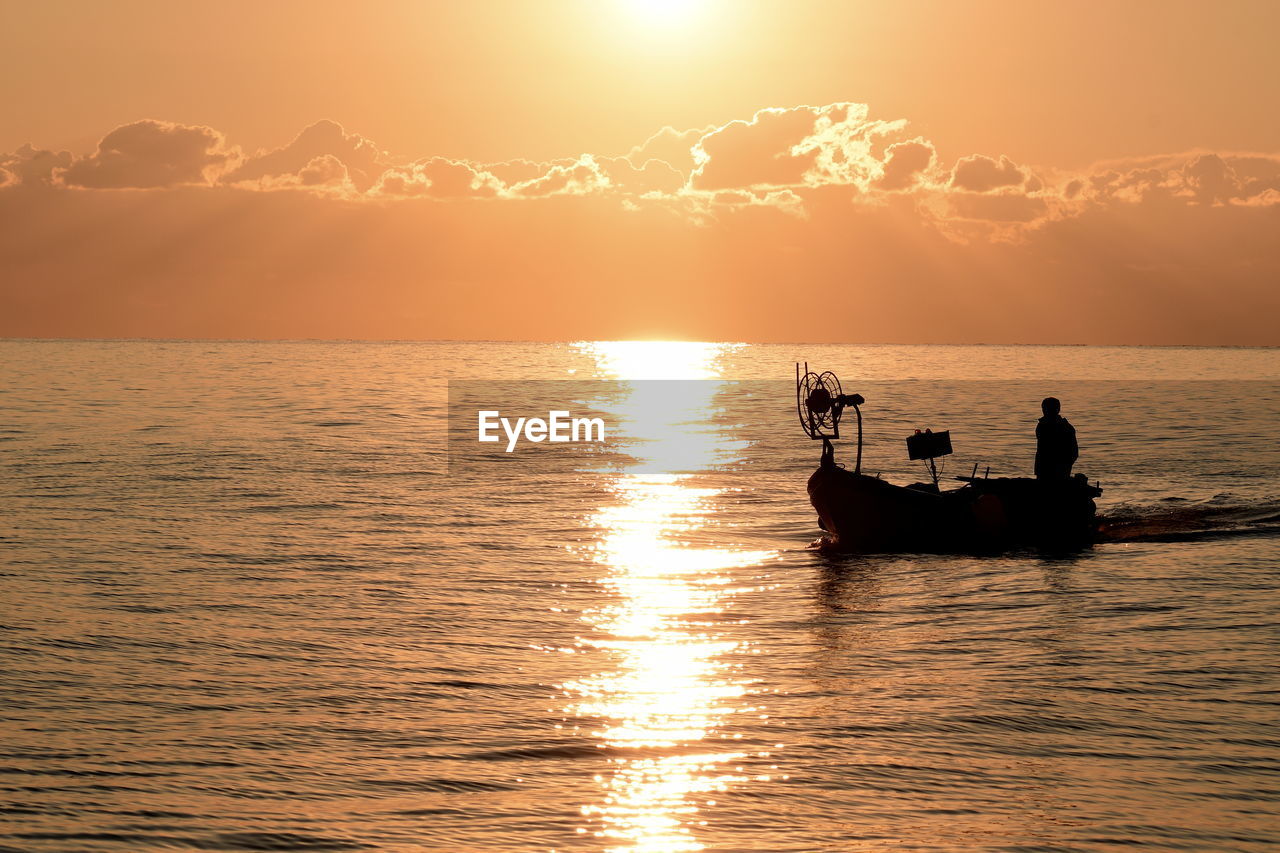 SILHOUETTE BOAT IN SEA AGAINST SKY DURING SUNSET