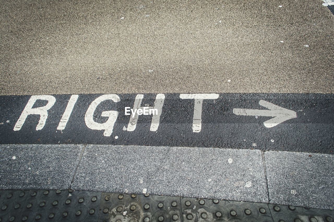 High angle view of right text with arrow on street