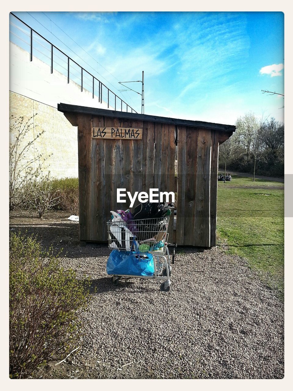 Full shopping trolley against cabin on landscape