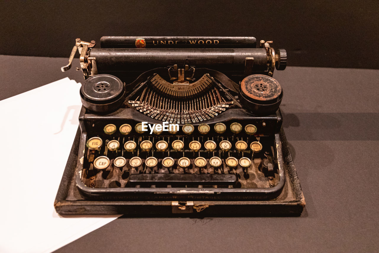 typewriter, retro styled, office equipment, office supplies, technology, history, table, indoors, the past, old, communication, no people, number, text, nostalgia, high angle view, paper, metal, single object, equipment, still life, close-up, machinery, analog, letter, copy space, studio shot