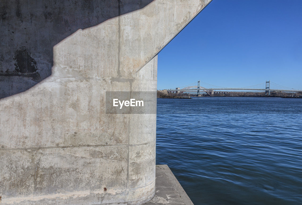 architecture, water, built structure, bridge, nature, travel destinations, sky, no people, transportation, sea, day, travel, city, clear sky, wall, outdoors, tourism, blue, building exterior, sunlight, sunny, history, the past, concrete, suspension bridge