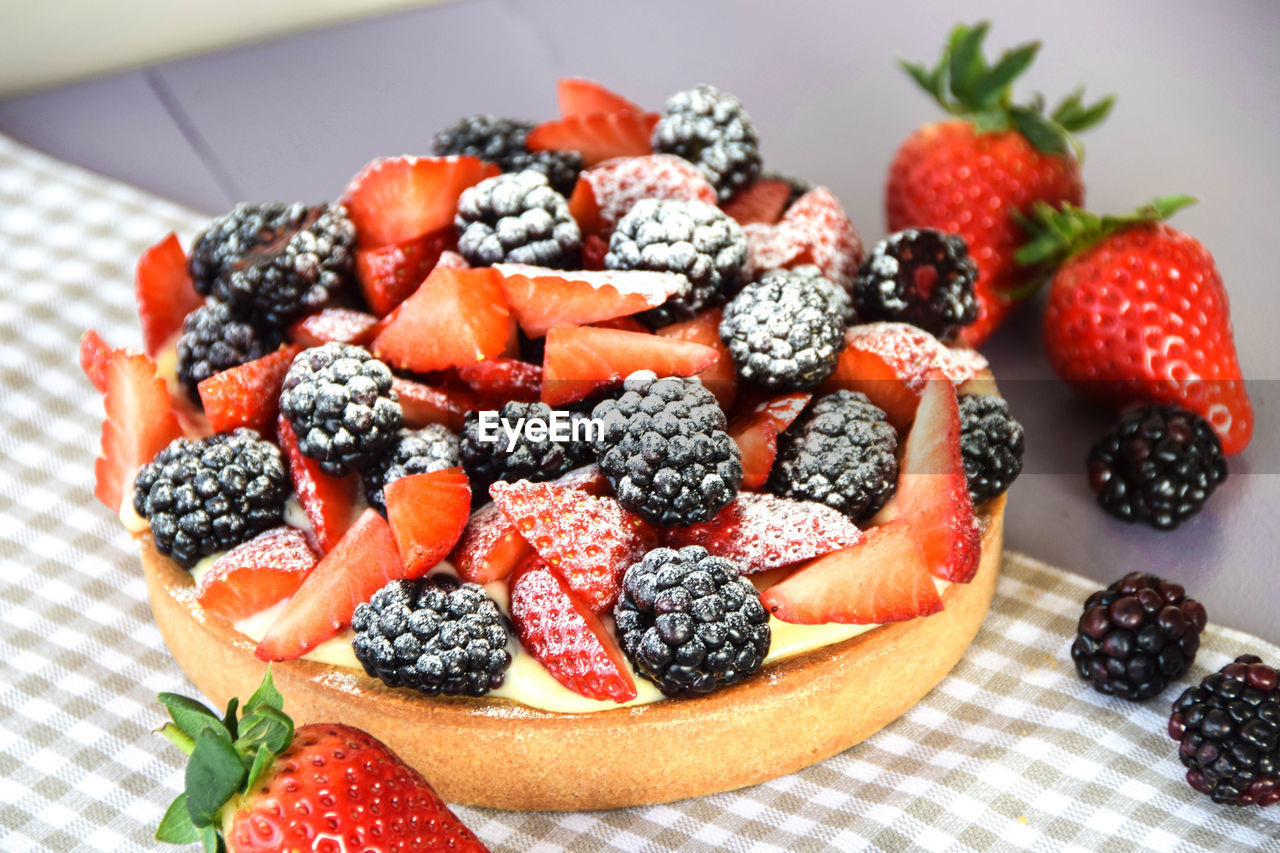 Close-up of strawberries in cake on table